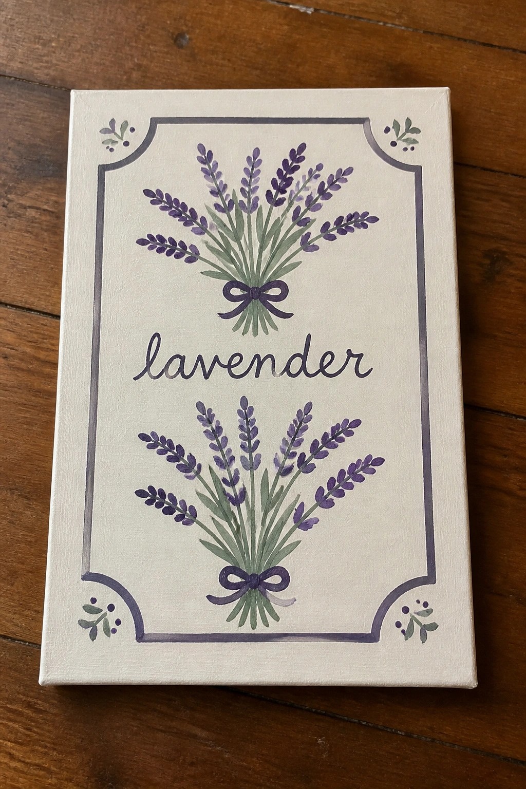 Hand-painted canvas with lavender bunches, purple bows, decorative border, and cursive text on wood.