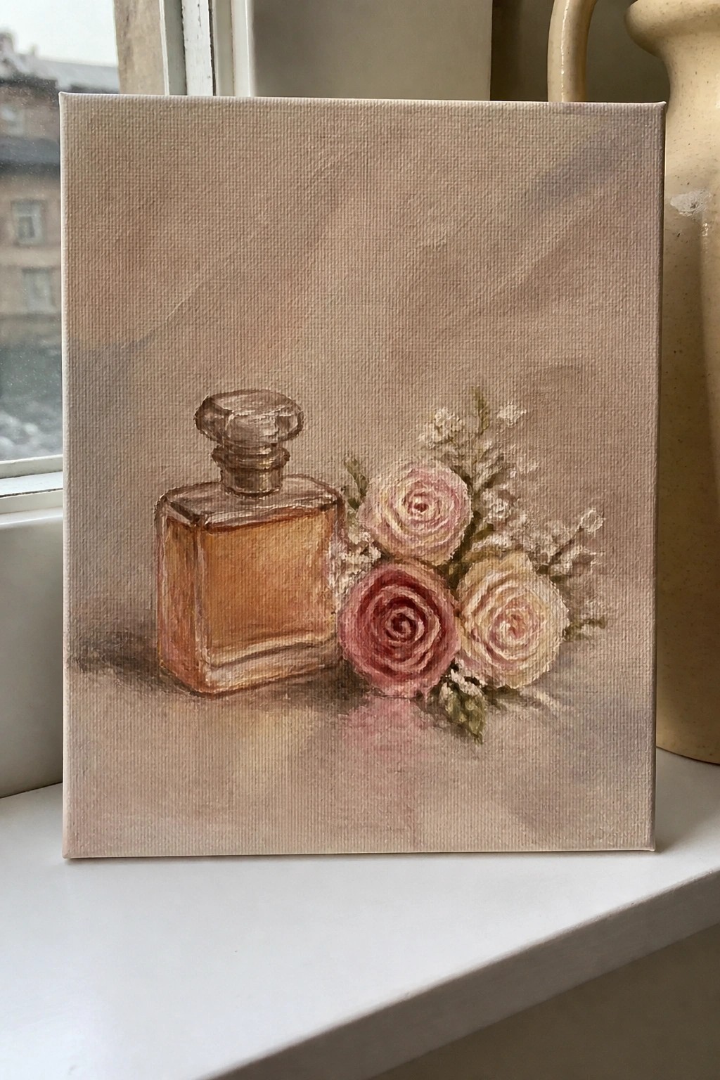 Painting of amber perfume bottle beside pink and cream roses on canvas