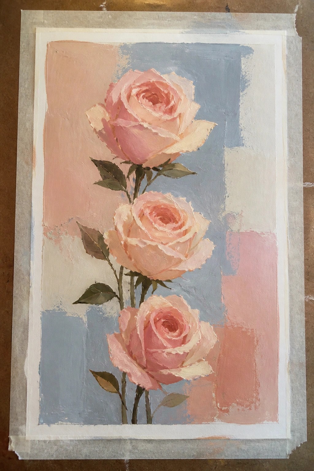 Three soft pink roses with leaves on abstract peach and blue background