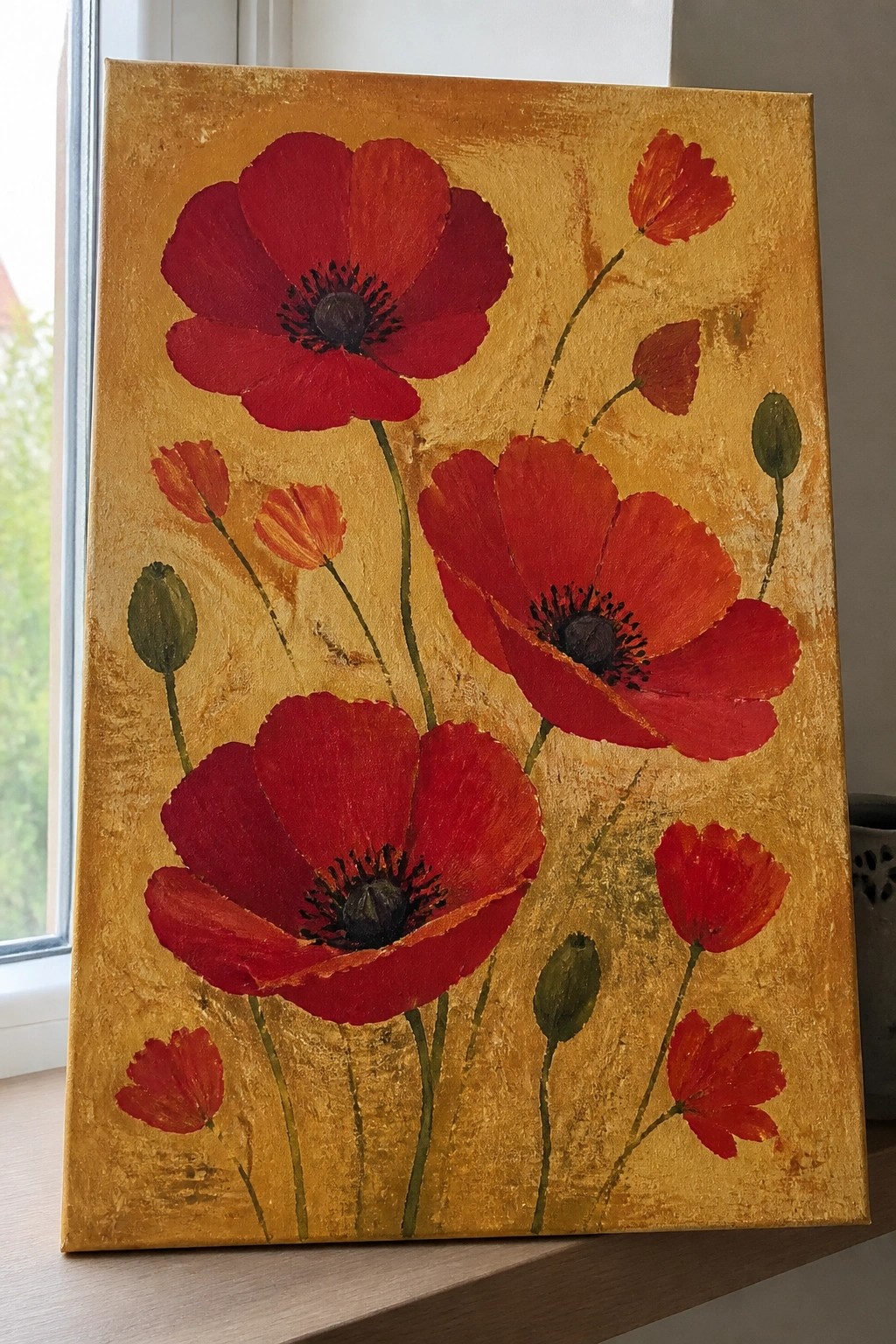 Vibrant red poppies with black centers on textured golden yellow background