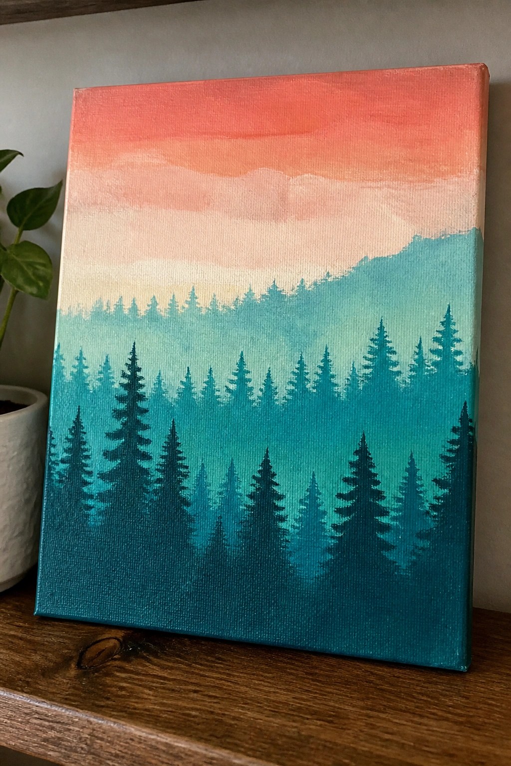 Layered teal pine forest beneath a red-orange-pink gradient sky on canvas
