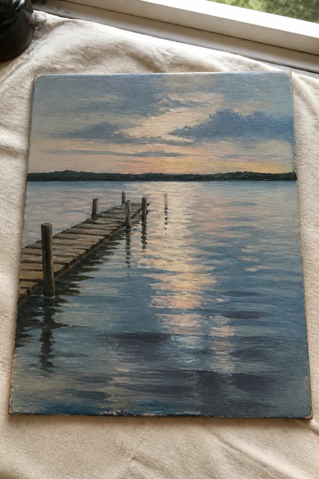 Oil painting of wooden pier over calm water with colorful sky reflections