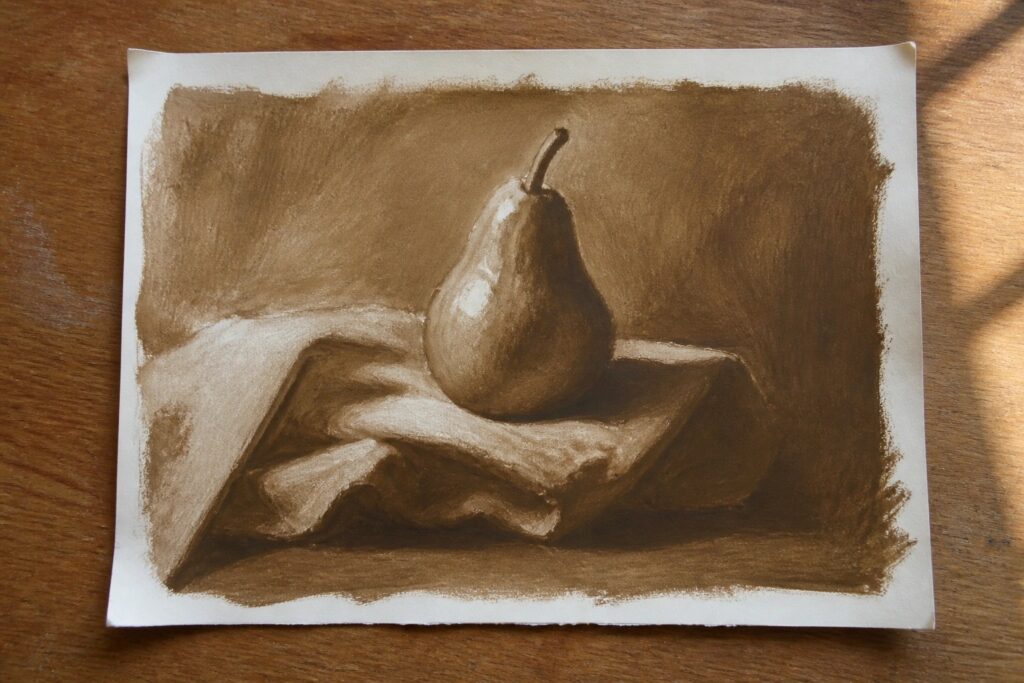 22 Powerful Oil Painting Projects To Rapidly Boost Your Skills Brown-toned still life drawing of a pear on draped fabric with shadows.