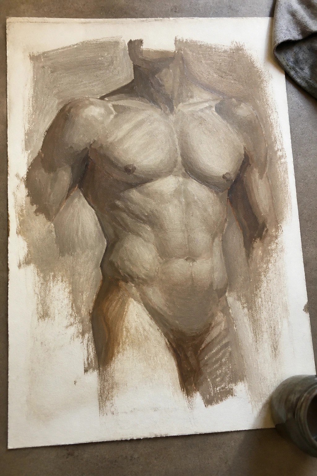 Brown and gray painting of muscular male torso on white paper with art supplies.