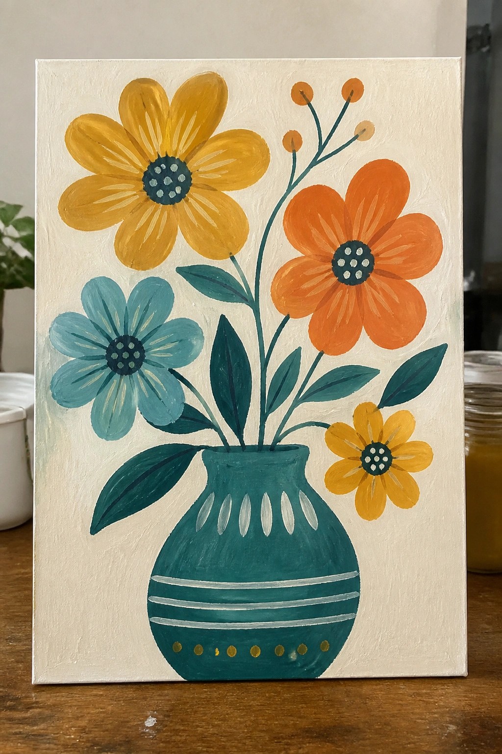 Colorful folk-style painting of flowers in a decorative teal vase on wood