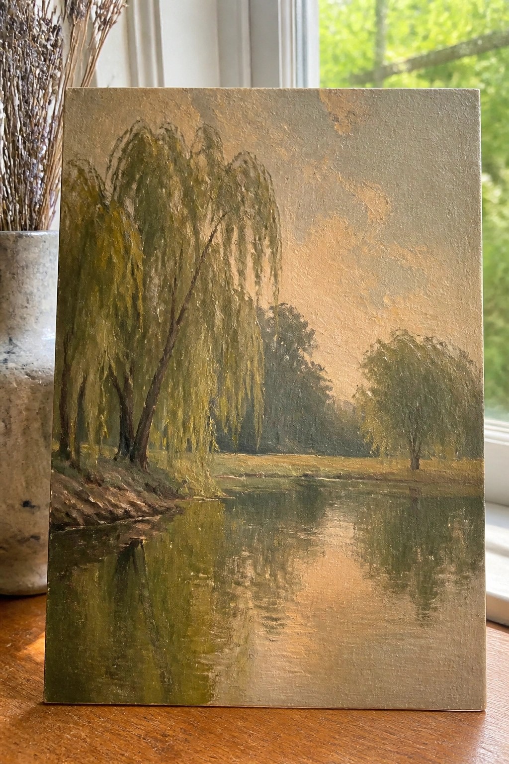 Impressionist painting of weeping willows reflected in a calm river at dusk.
