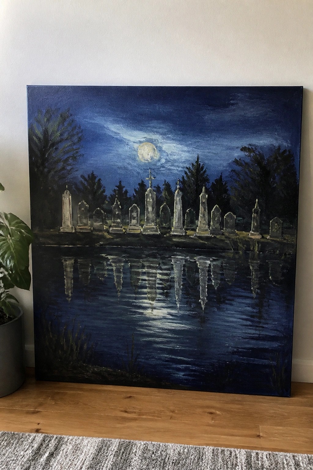 Moonlit graveyard painting with tombstones reflected in dark blue water at night