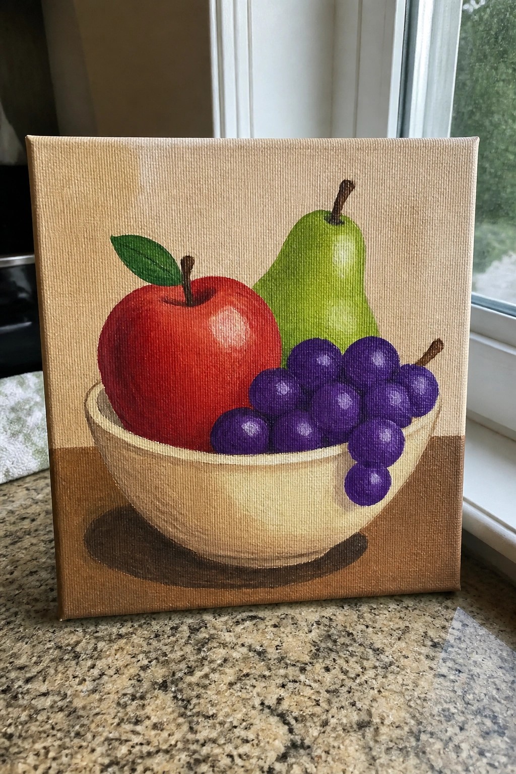 Painting of red apple, green pear, and purple grapes in beige bowl on canvas