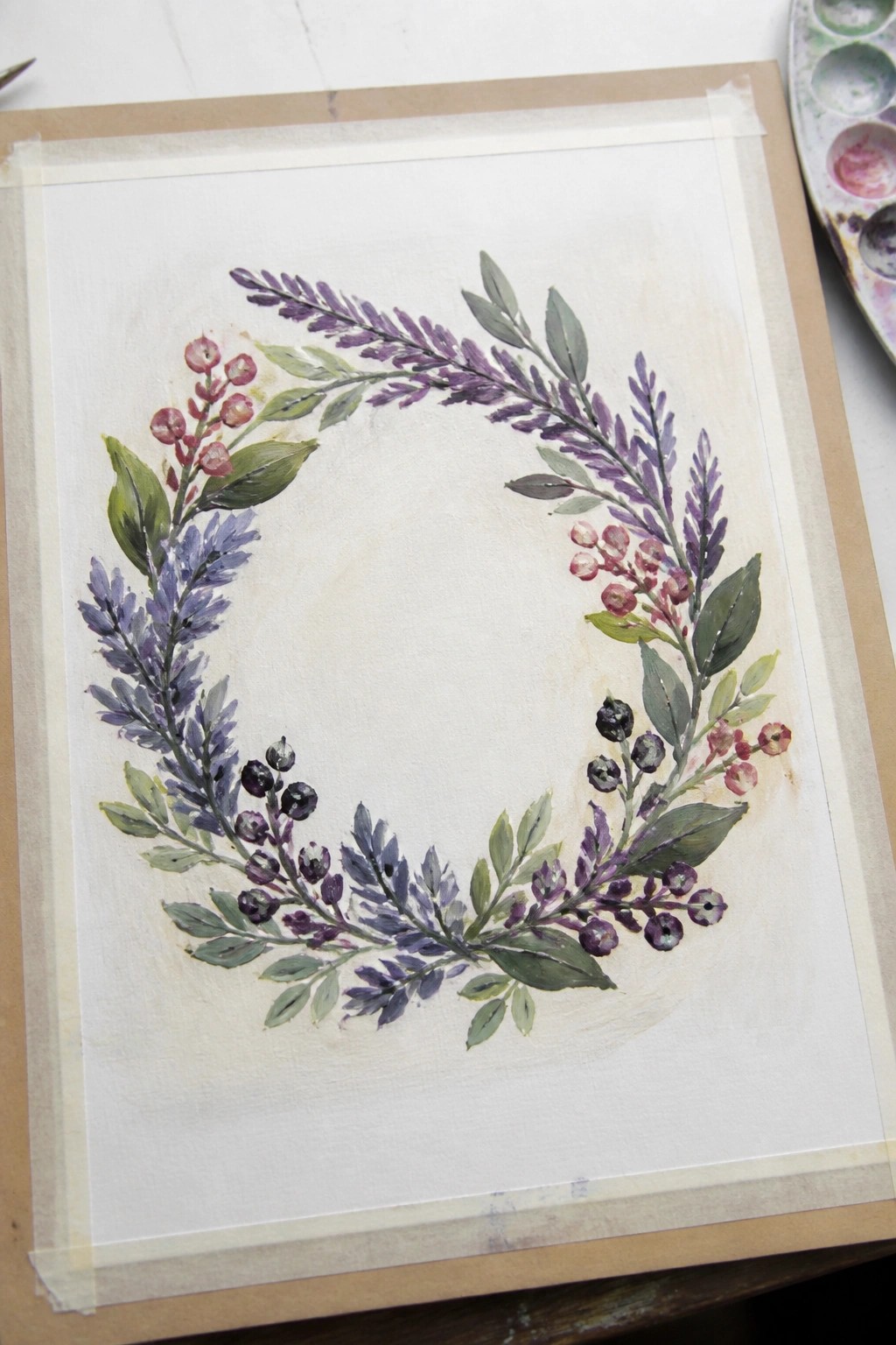 Watercolor wreath with purple foliage, green leaves, and pink-black berries on paper