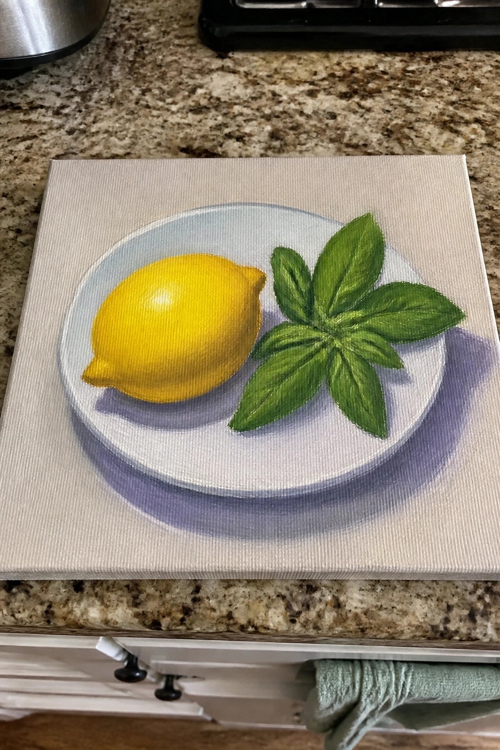 Yellow lemon and green leaves on white plate with blue rim, painted on canvas.