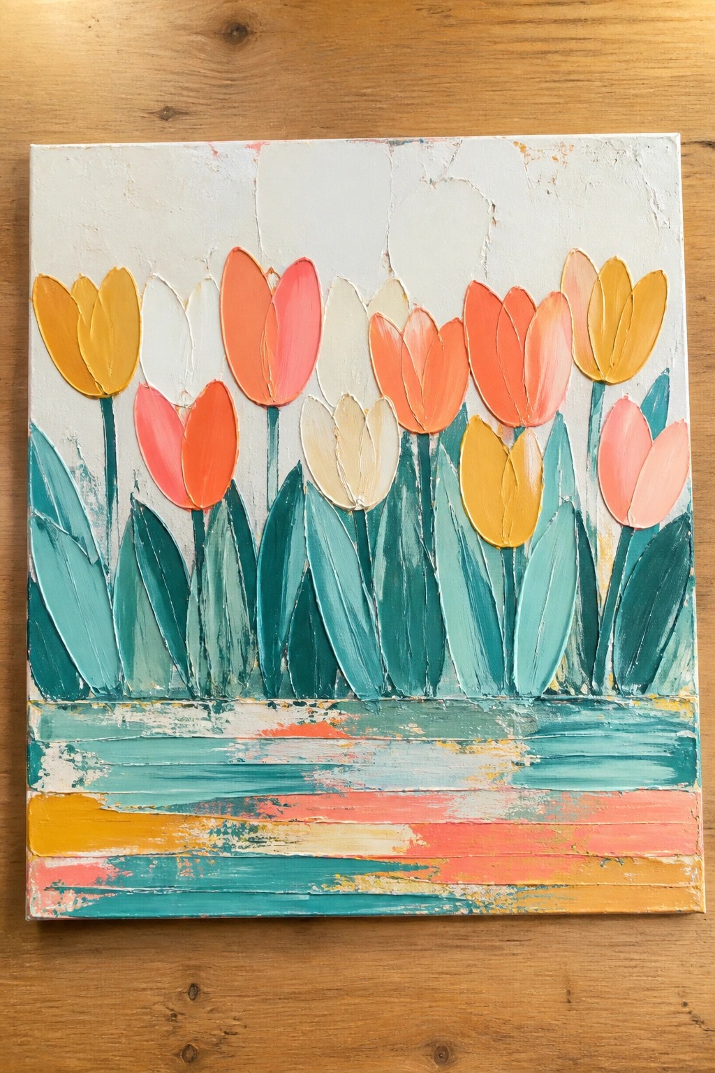 Colorful abstract tulip painting with orange, yellow, pink blooms and teal leaves.