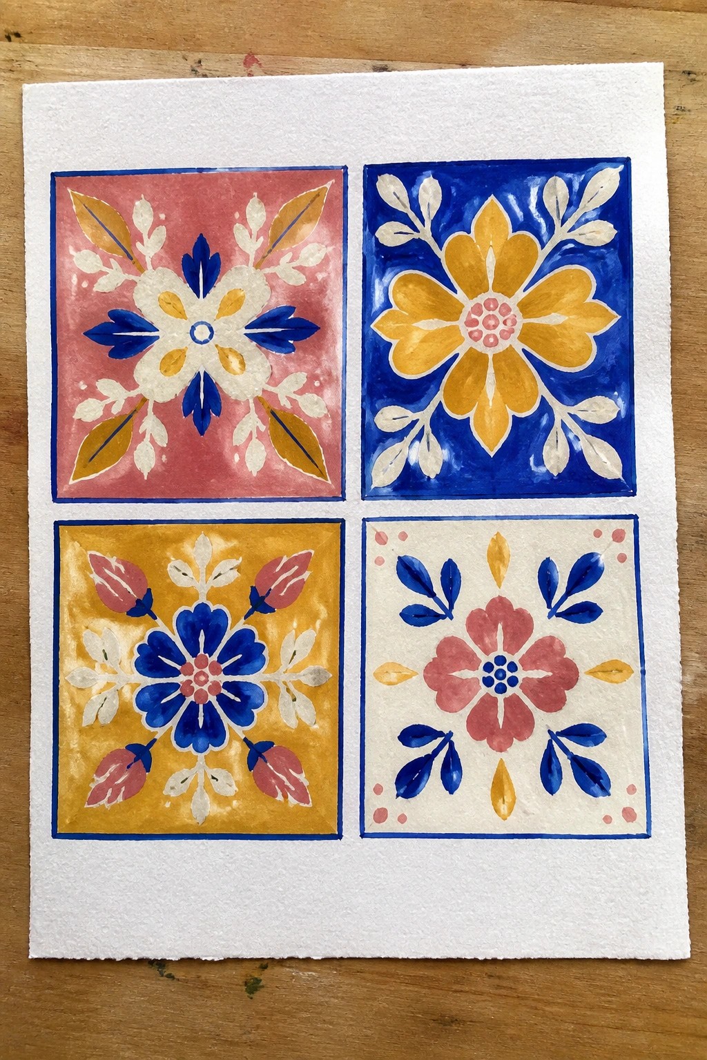 Four vibrant watercolor floral tiles in pink, blue, yellow, and white grid.