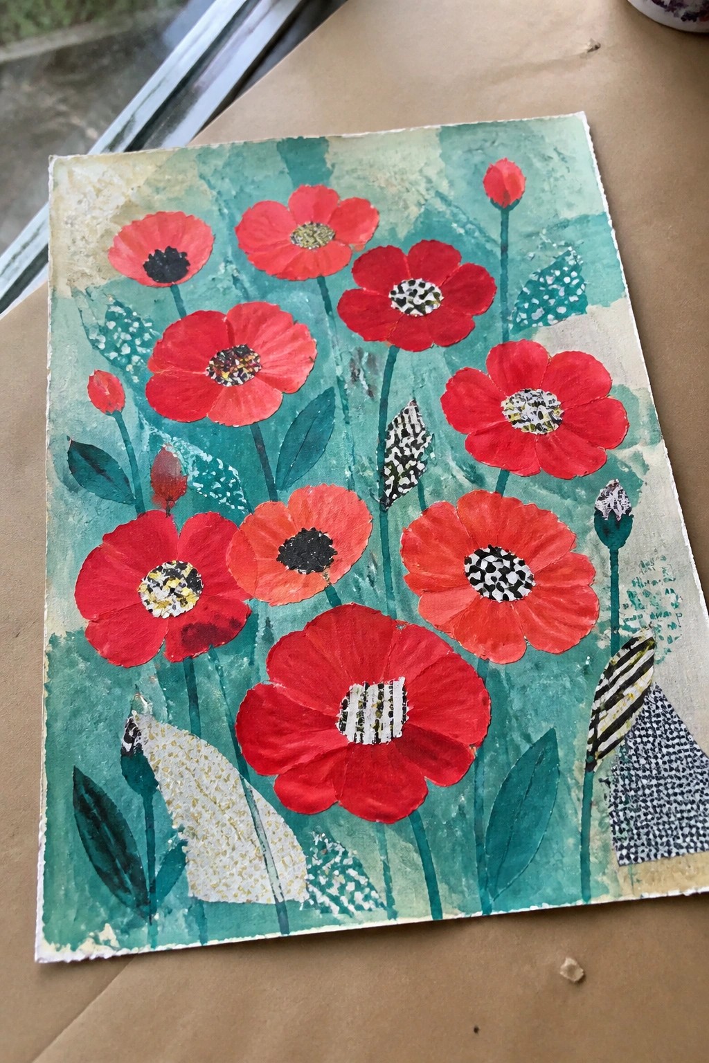 A mixed media collage of red poppies with patterned centers and green stems on a teal background.
