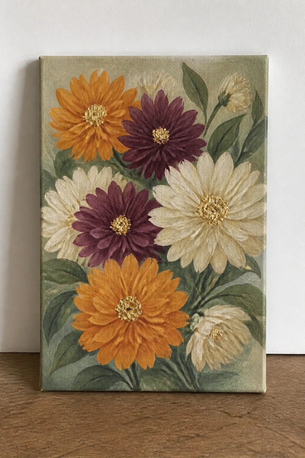 Vibrant painting of orange, purple, and white flowers with gold centers and green leaves.