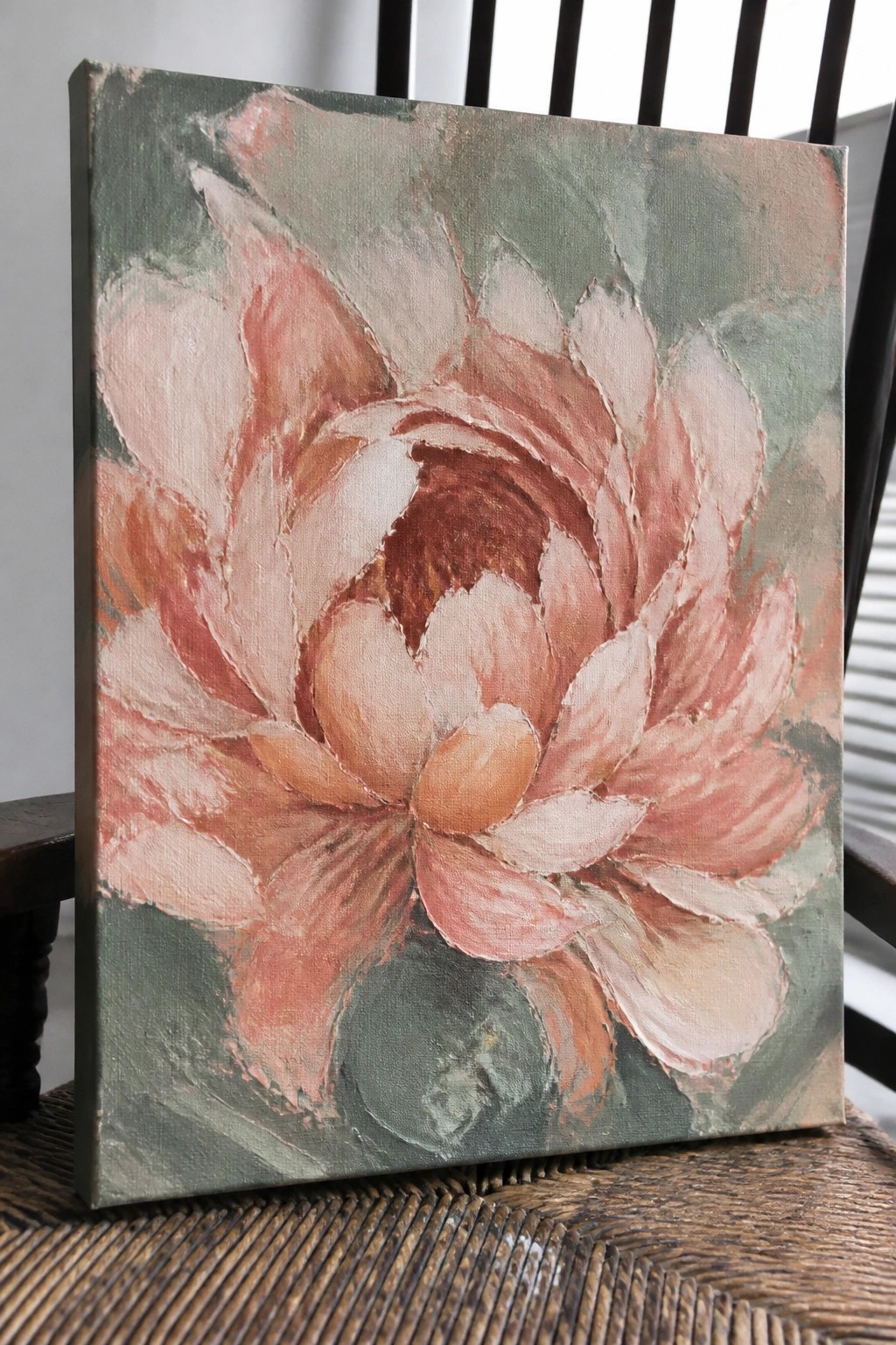 Textured oil painting of a blooming coral-pink flower on green canvas.