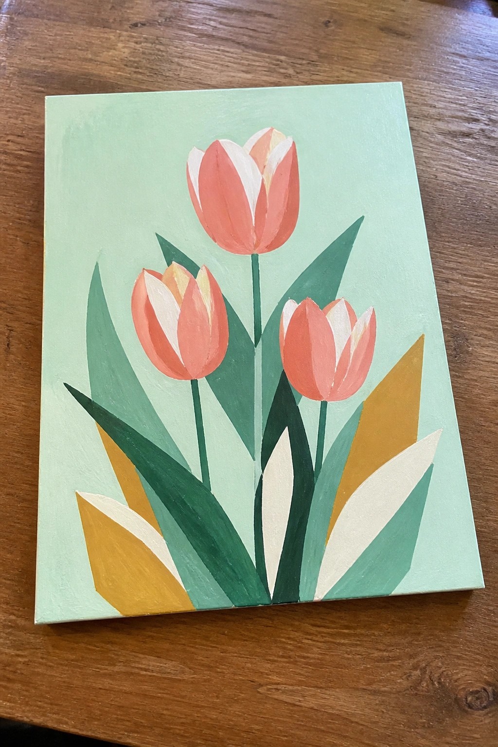 Stylized painting of three pink tulips with green leaves on light green canvas.