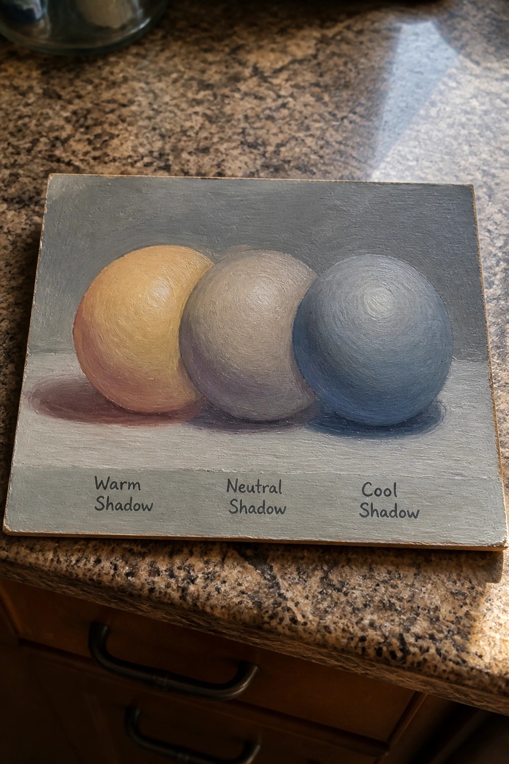 Oil painting of three spheres on a gray surface with labels showing warm, neutral, and cool shadows.