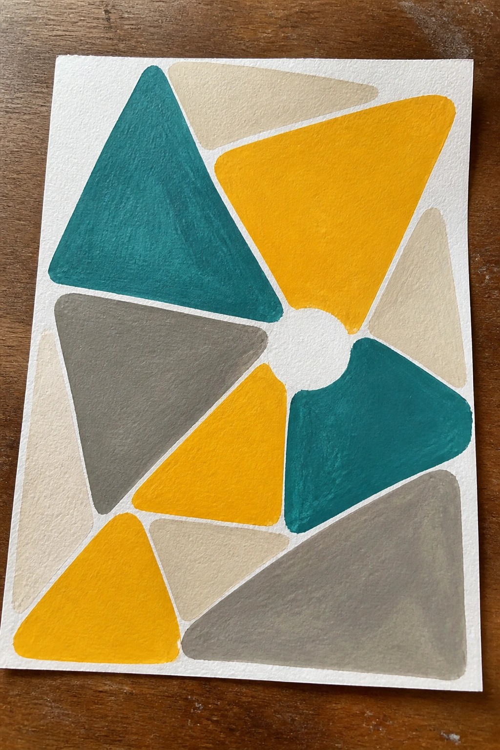 Abstract geometric painting with colorful triangles in teal, yellow, and gray around a white circle