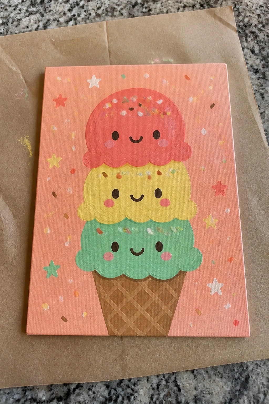 Cute acrylic painting of triple-scoop ice cream cone with smiling faces on pink background.