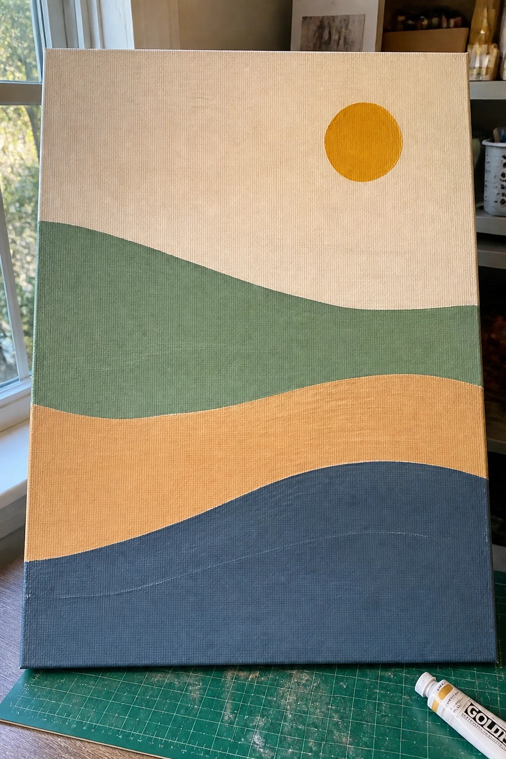 Abstract canvas painting with wavy green, orange, and blue layers beneath a yellow sun