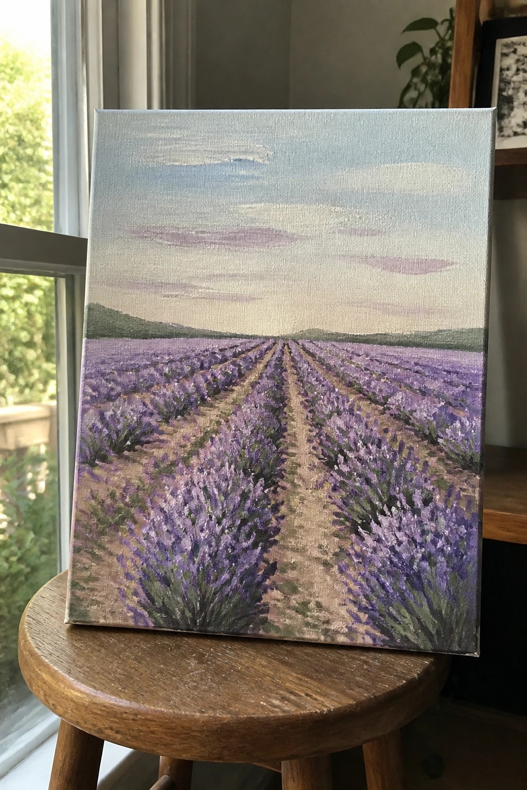 Lavender field painting with purple rows under pastel sky on wooden stool