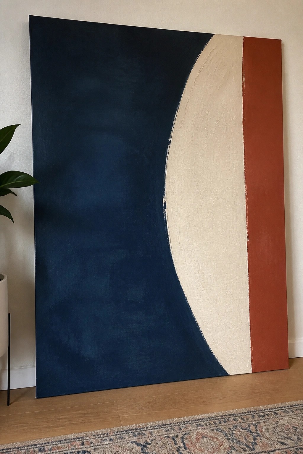 Large abstract painting in navy blue, cream, and rust orange with curved shapes
