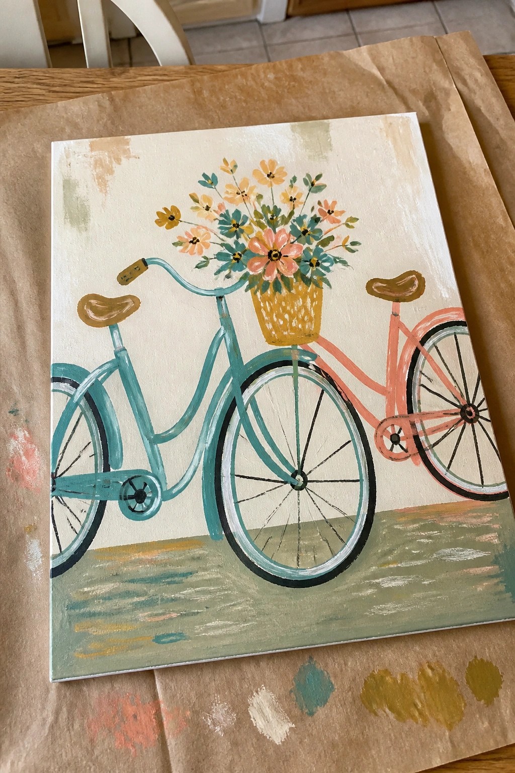 Teal and pink bicycle painting with basket of colorful flowers on canvas