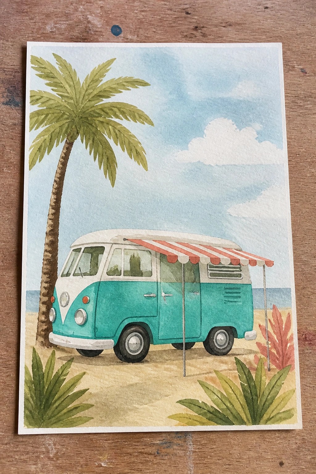 Turquoise VW bus with red striped awning on sandy beach beside palm tree