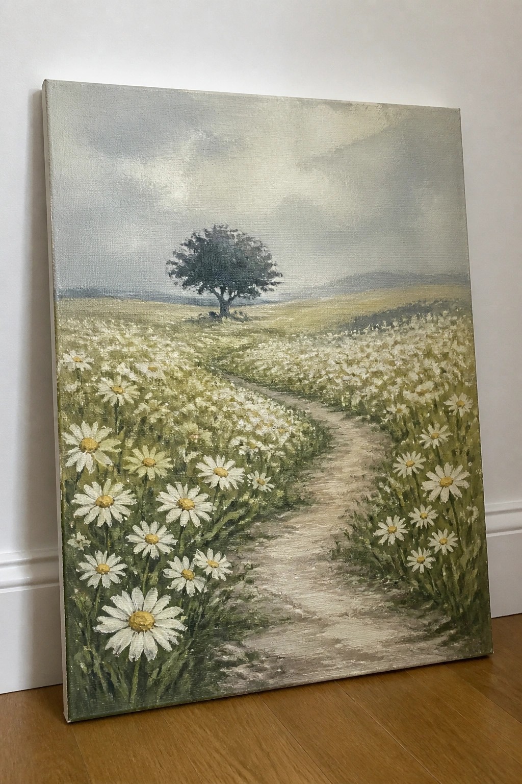 Canvas painting of daisies lining a winding path to a lone tree under clouds.