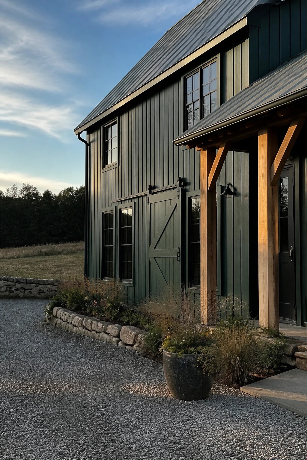 Dark green vertical siding on a rural house exterior with wooden support beams and stone accents.