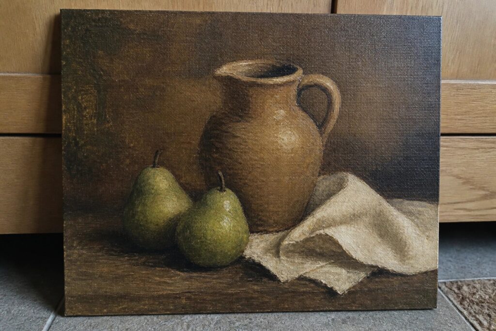 Still life painting with brown ceramic pitcher, two pears, and white cloth on wood.