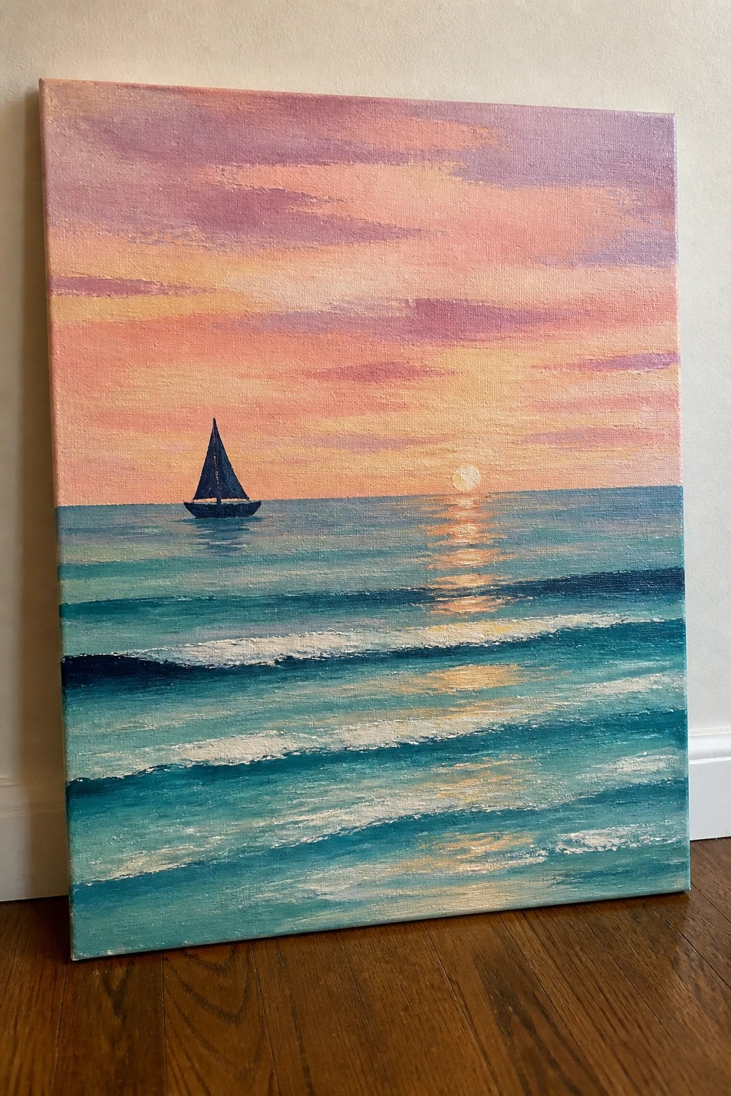 Sailboat on turquoise waves under pink orange sunset sky with sun reflection.