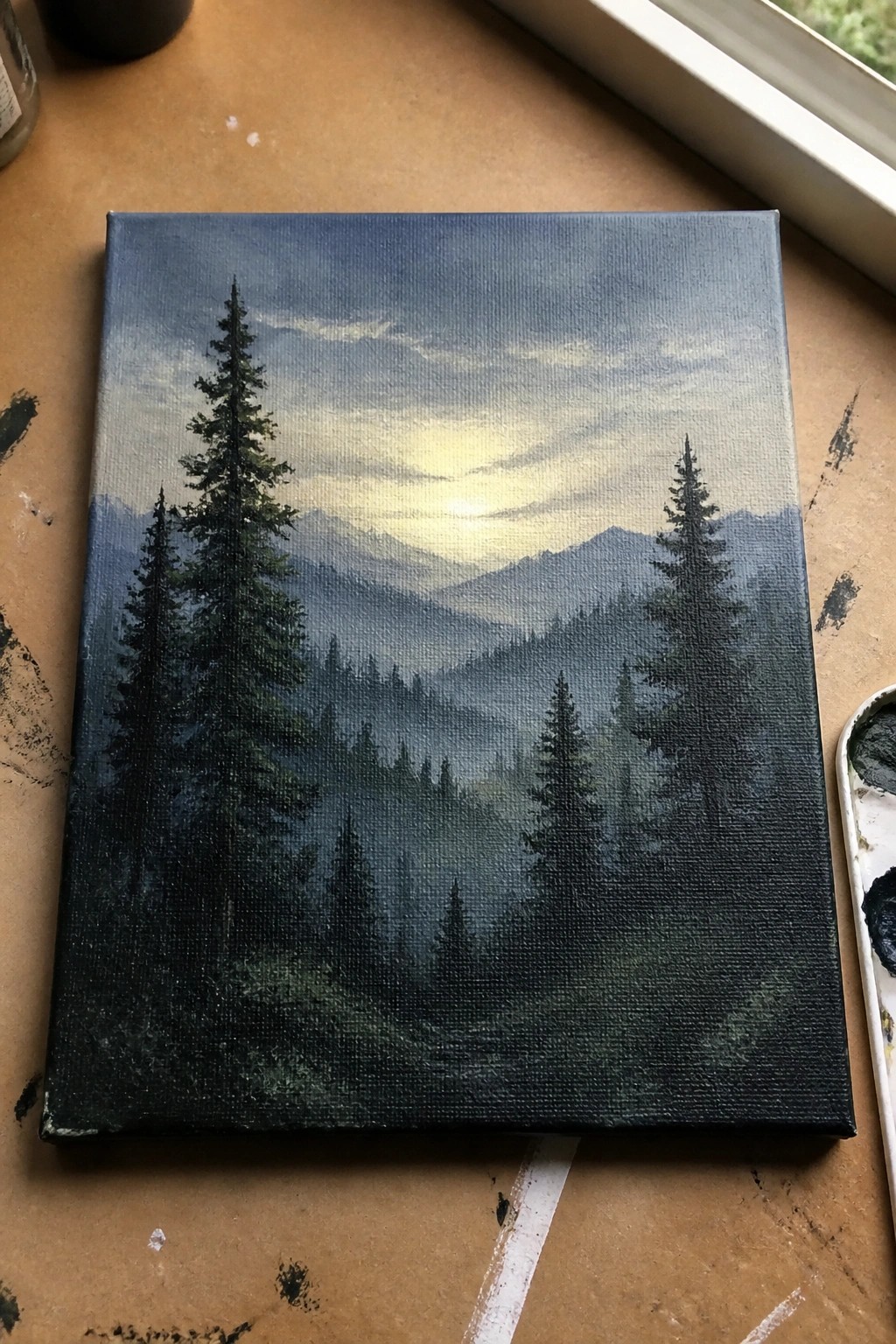 Atmospheric landscape painting of misty mountains with silhouetted pine trees on canvas