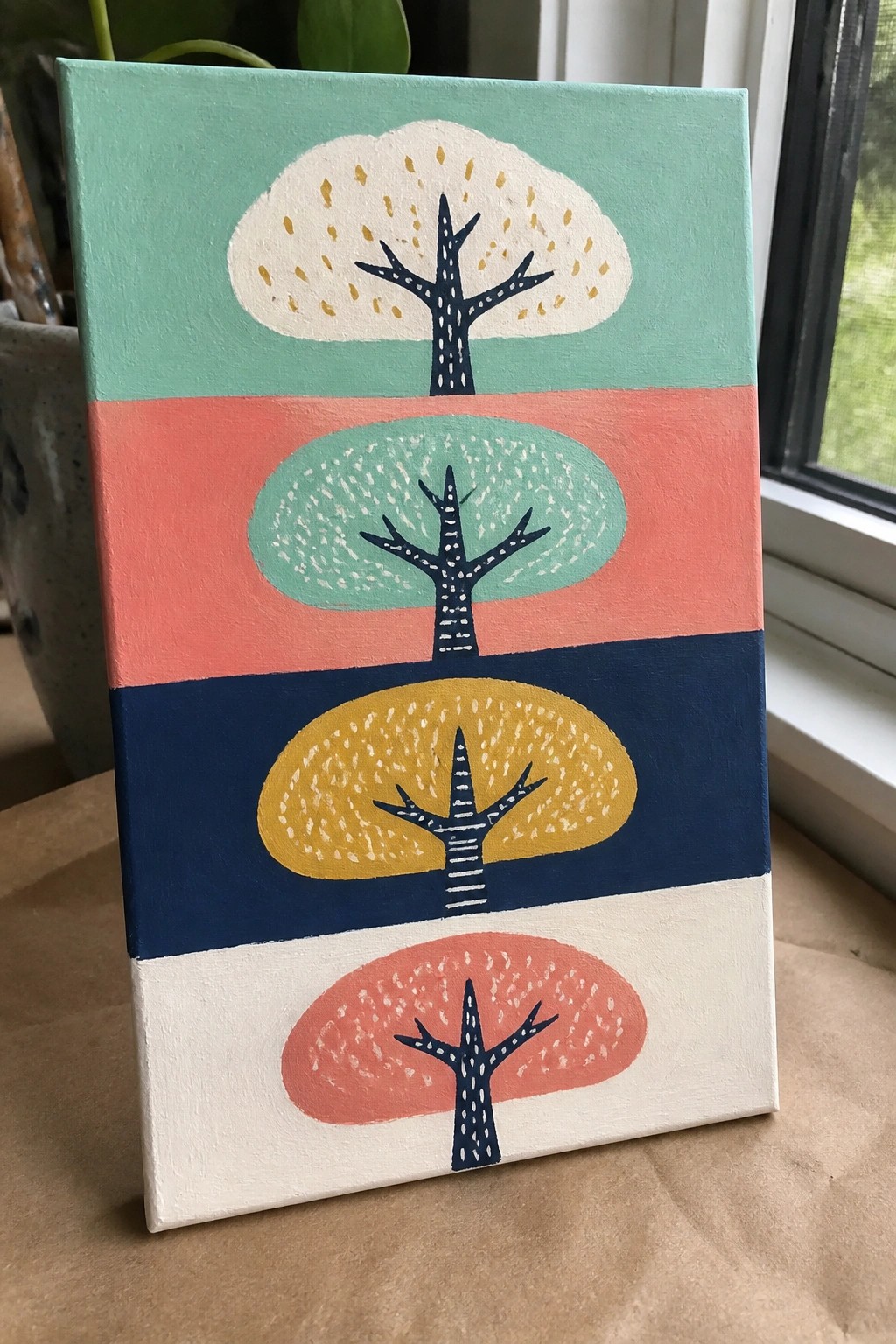 Abstract painting of four stylized trees on teal, coral, navy, and white stripes.