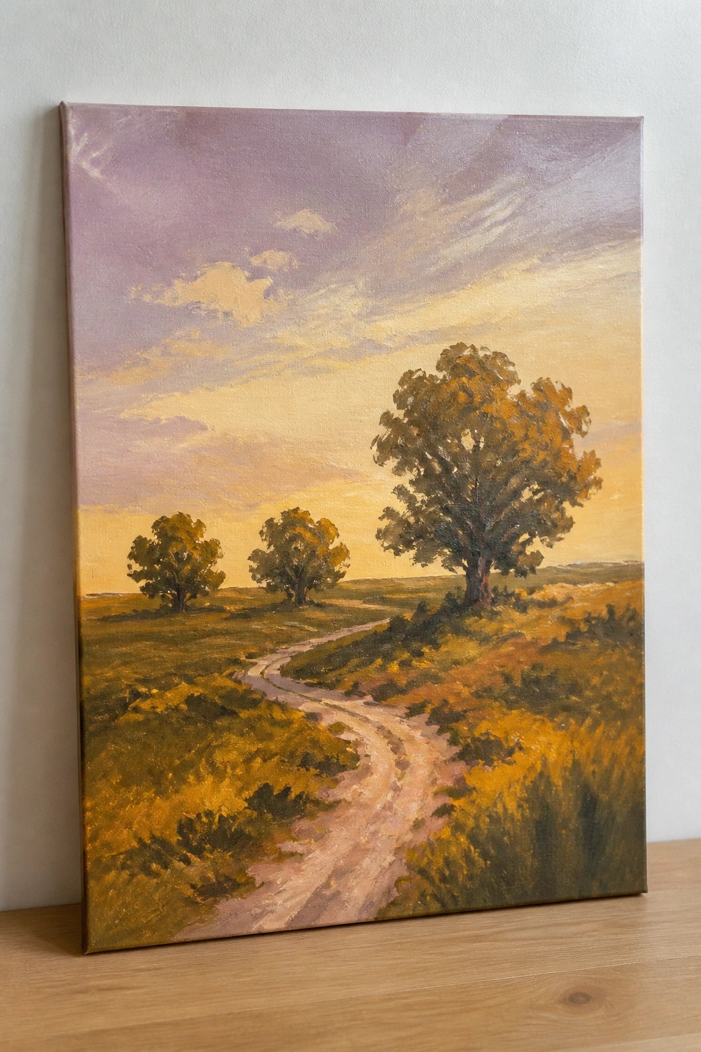 Oil painting of winding path through golden fields with trees under purple sunset sky.