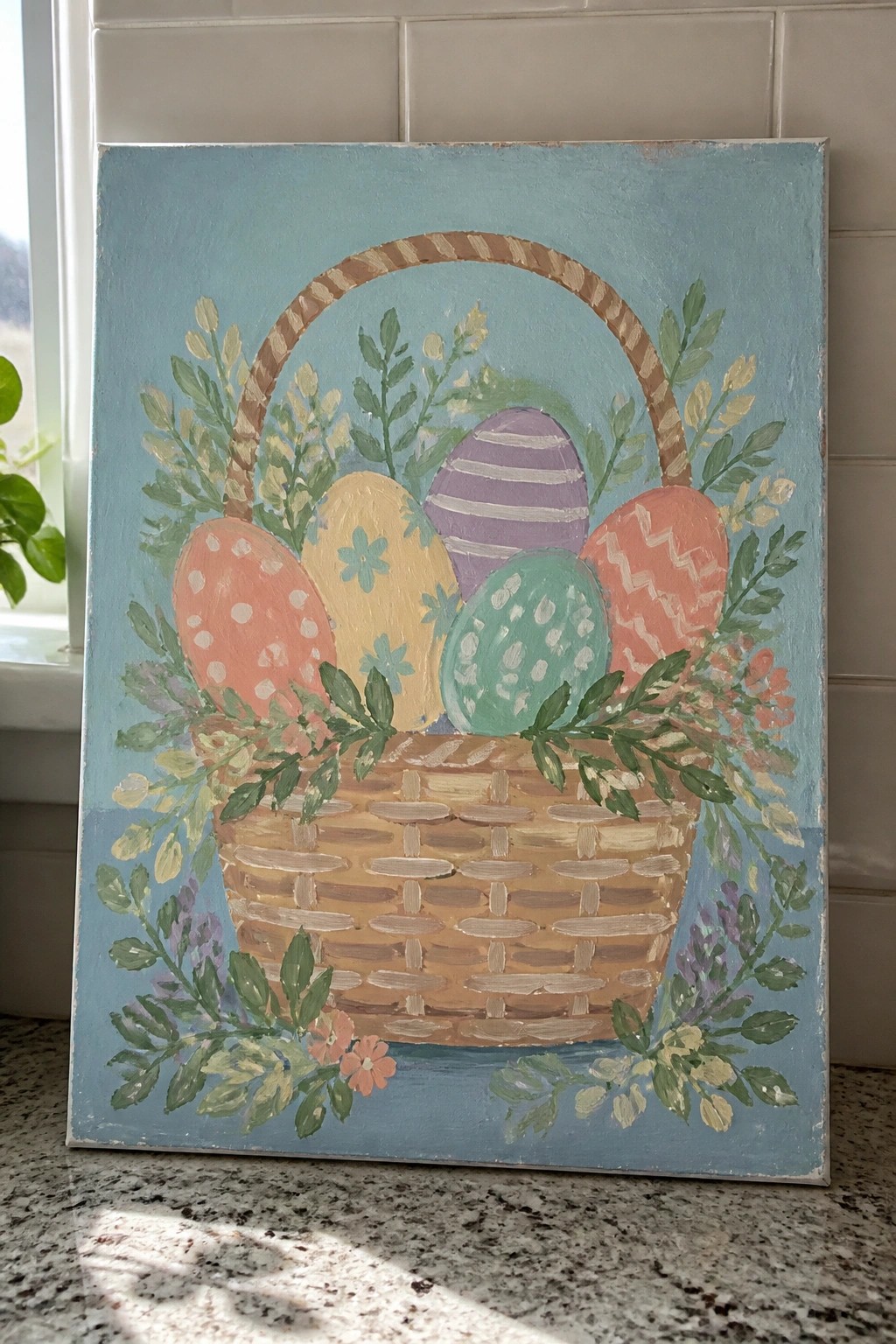 Painted Easter basket with colorful eggs, flowers, and greenery on blue background