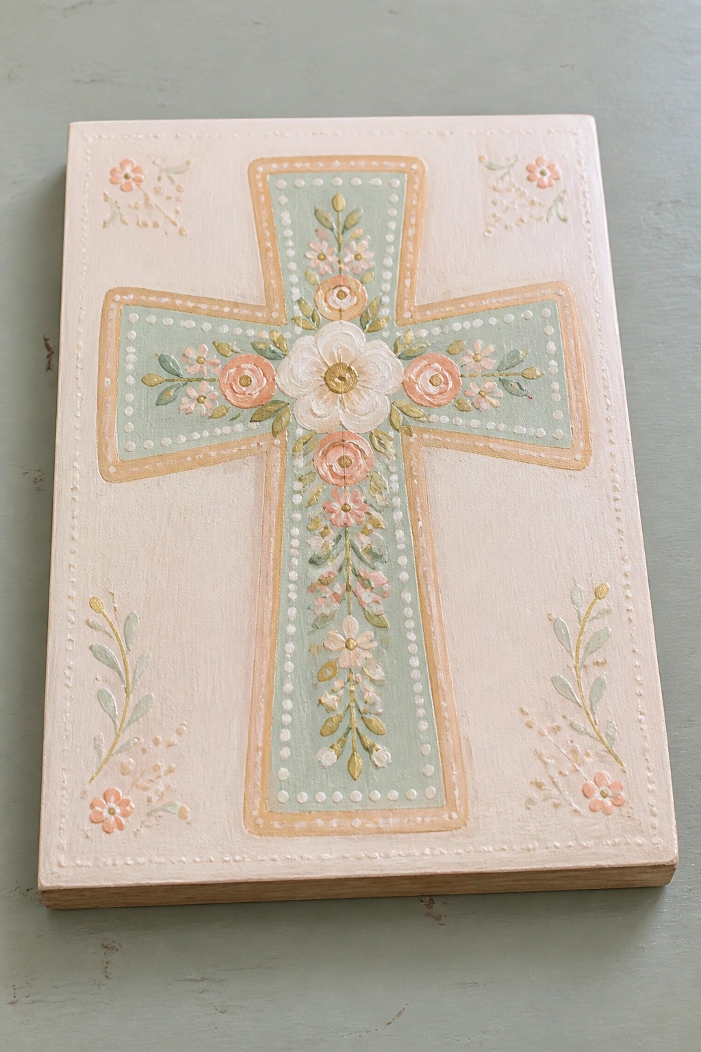 Pastel pink wooden plaque featuring a mint green cross with pink and white florals.
