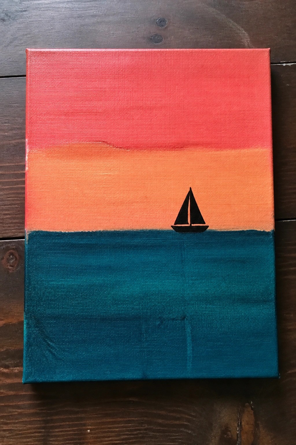 Minimalist canvas painting of black sailboat on teal sea under red-orange sunset sky.