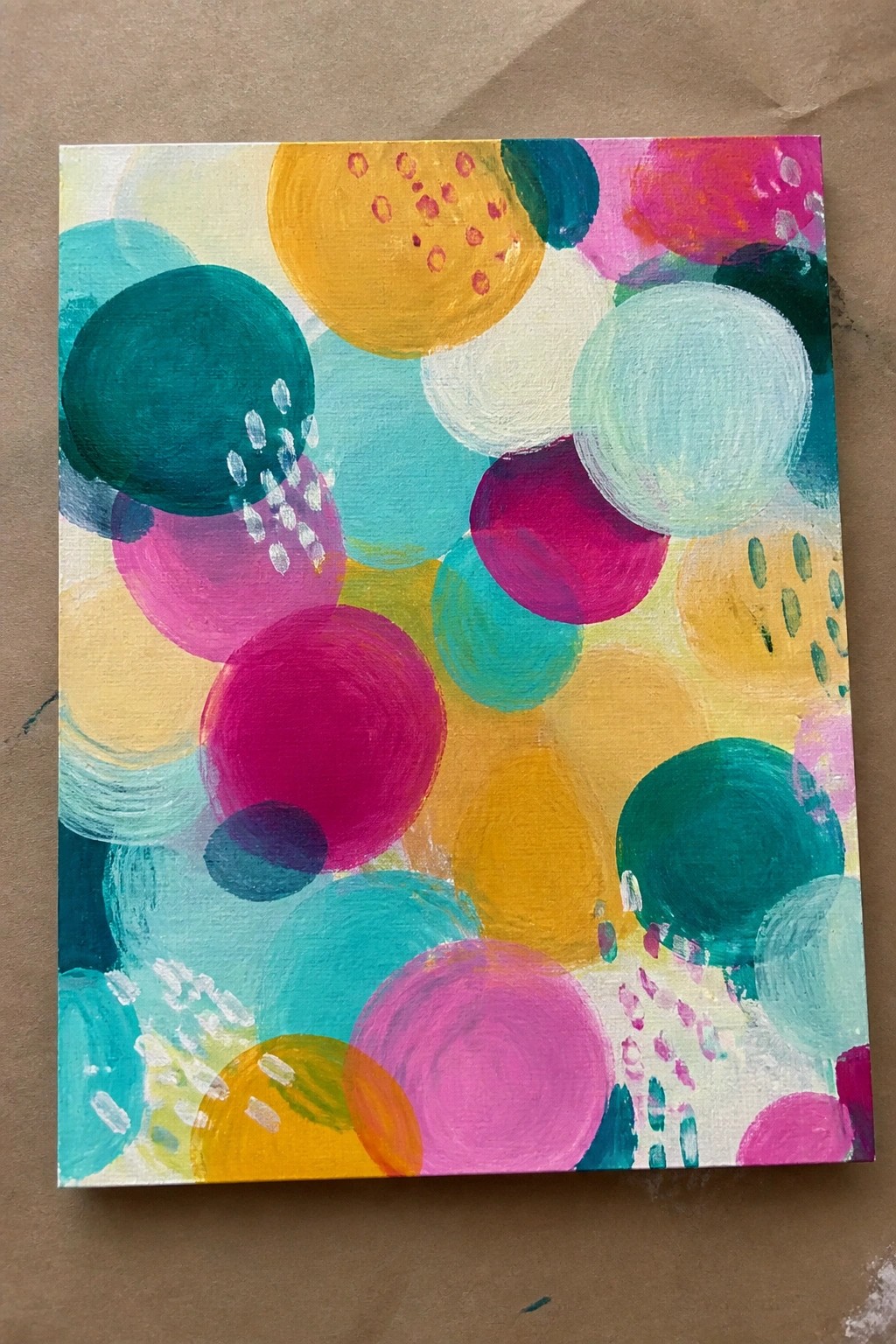 Vibrant abstract painting of overlapping colorful circles in bright hues.