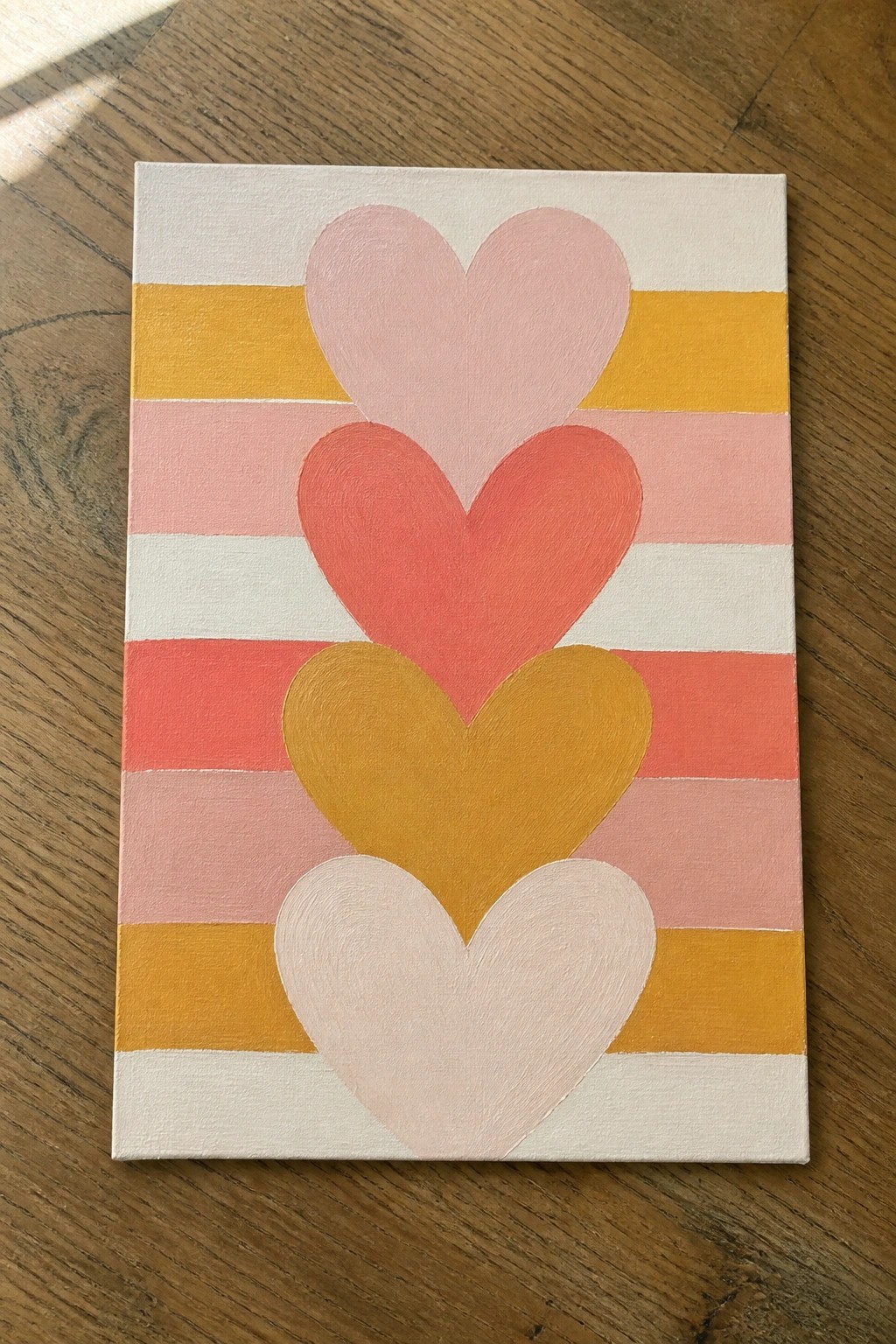 Colorful hearts layered over horizontal stripes in pink, yellow, and white