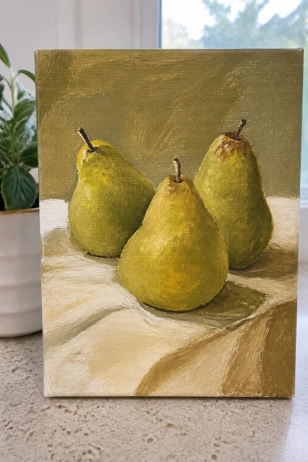 Three green pears rest on a white surface against an olive backdrop in this painting.