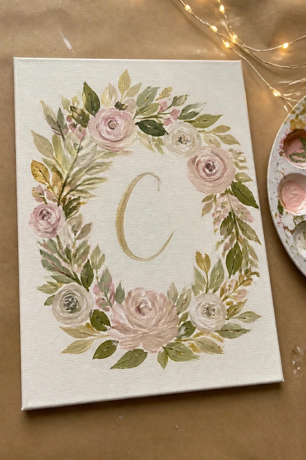 White canvas with pink rose wreath and gold letter C in center