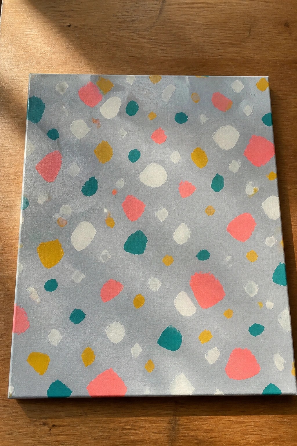 Abstract canvas with scattered pink, yellow, teal, and white dots on light blue-gray.