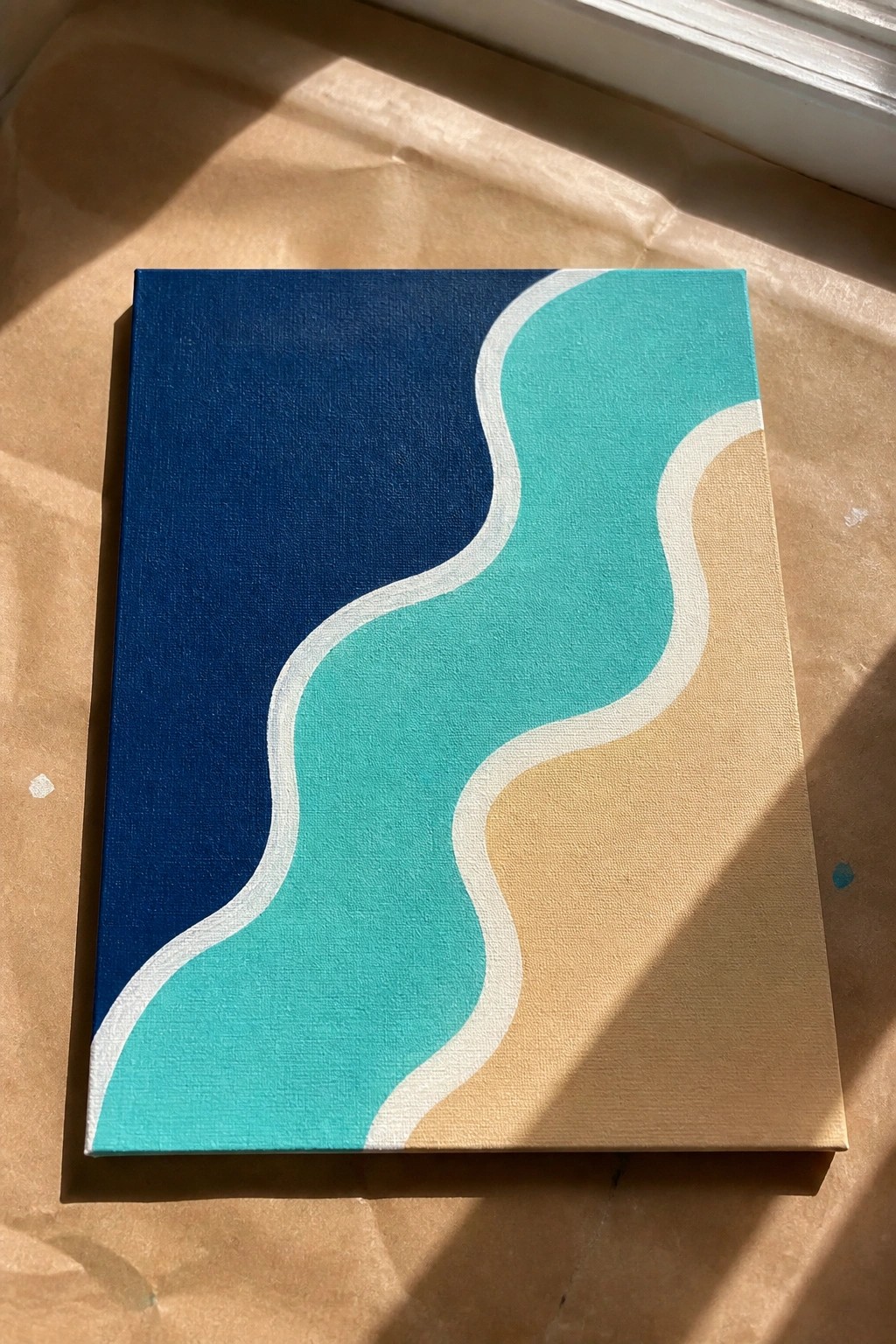 Abstract canvas with wavy lines in navy blue, teal, and beige sections