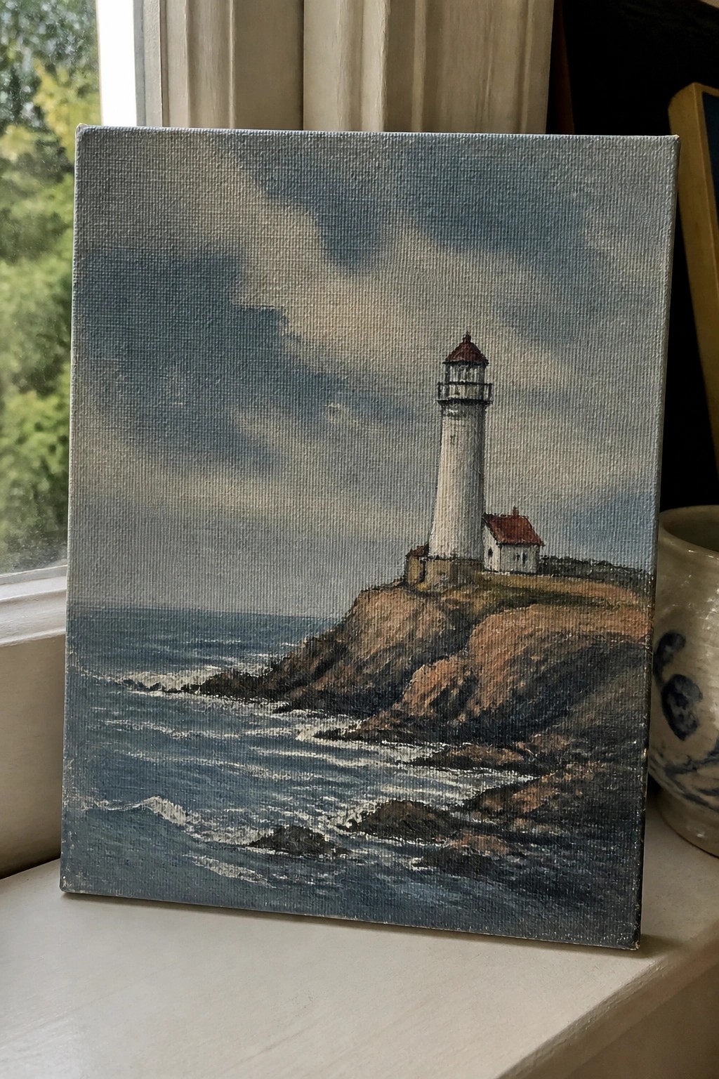 Oil painting of a white lighthouse on a rocky cliff beside the ocean under a cloudy sky.