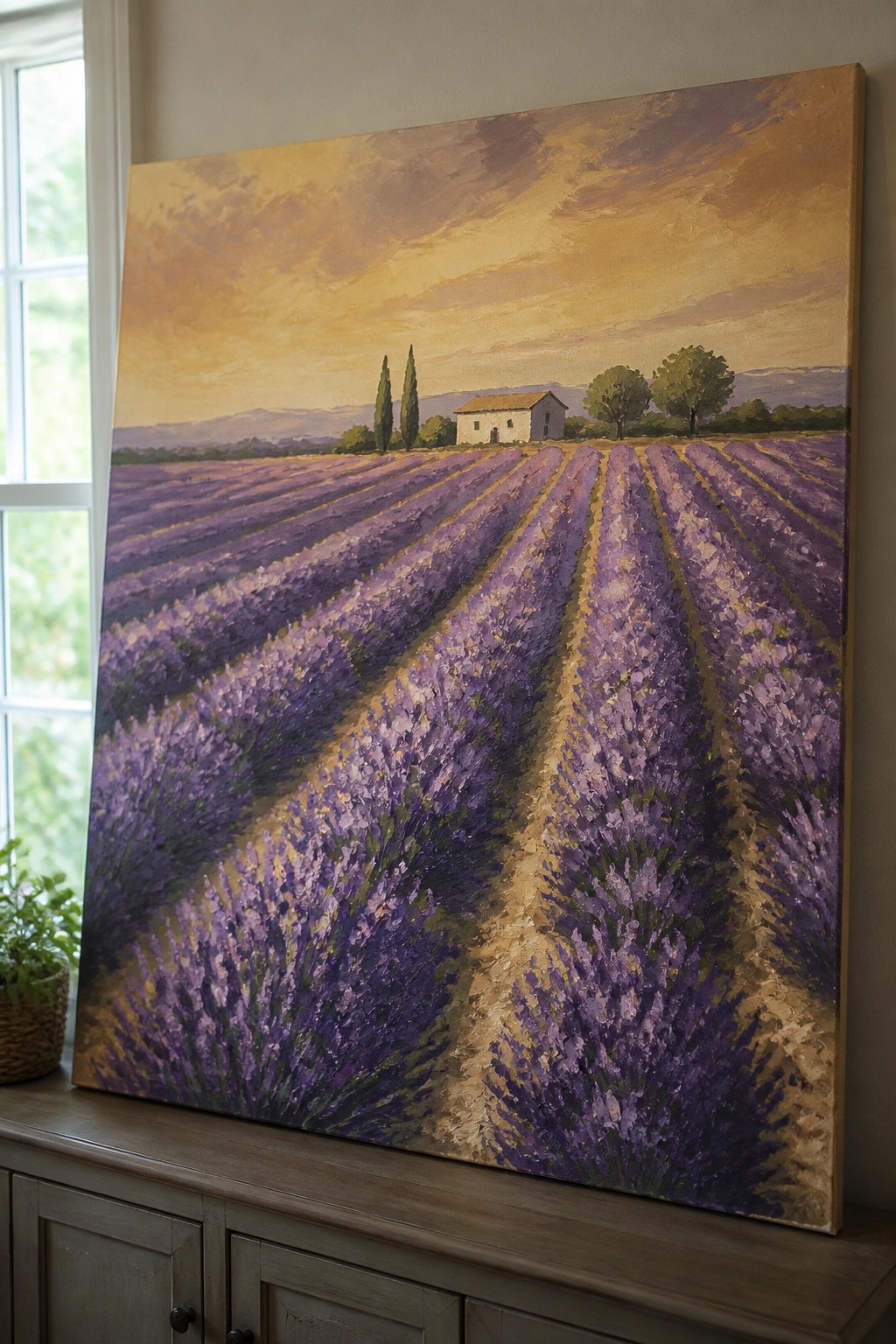 Large painting of purple lavender rows under golden sky on wall above cabinet