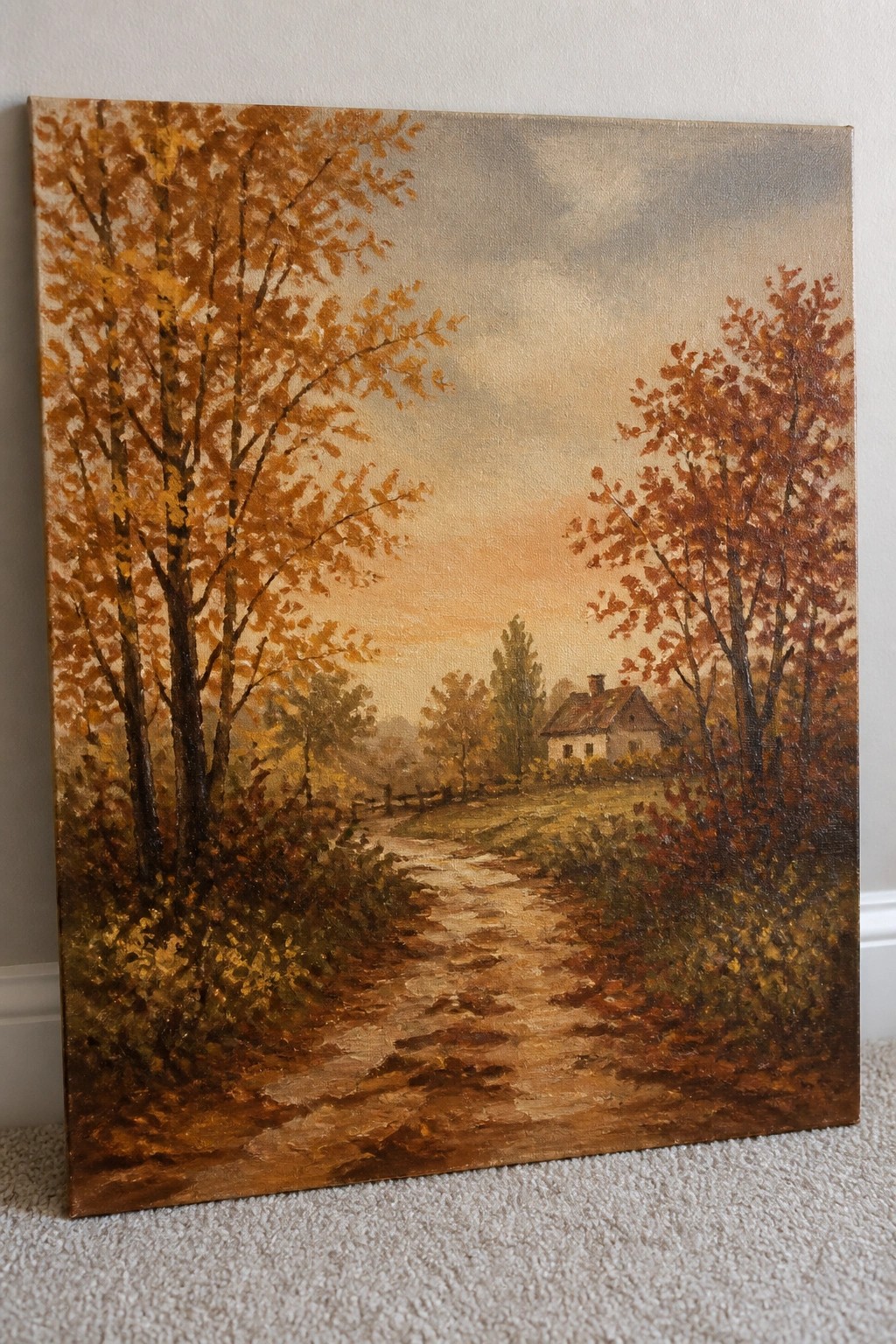 Autumn landscape painting of winding dirt path amid orange trees toward a cottage.