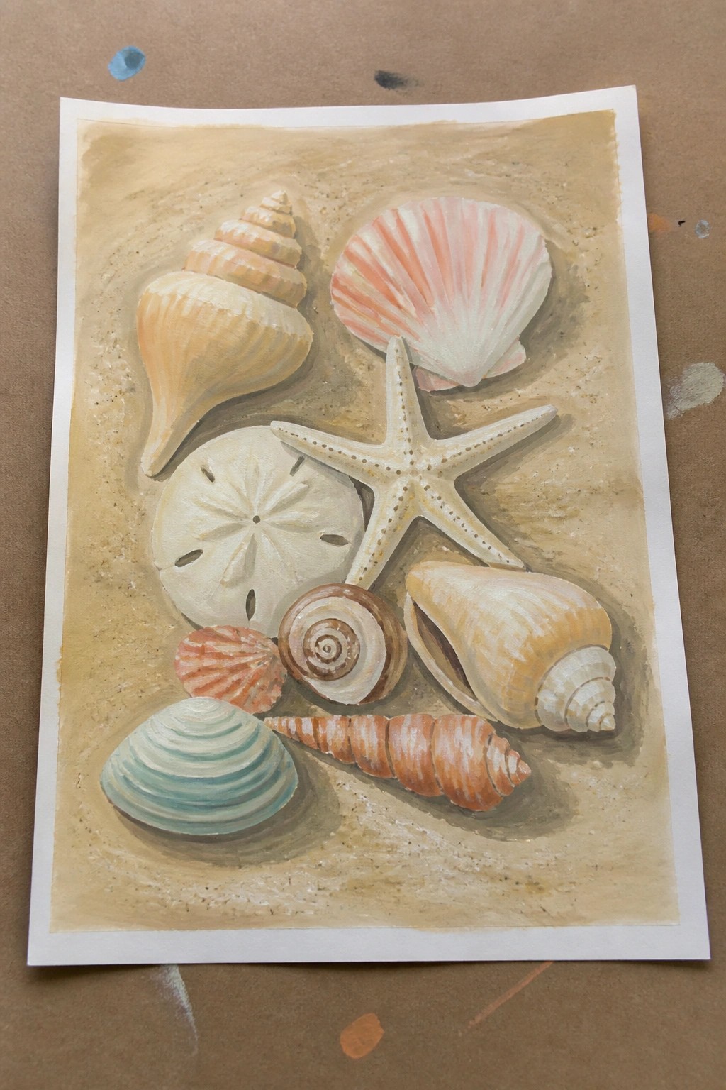 A realistic acrylic painting of various seashells, a starfish, and a sand dollar arranged on a sandy surface.