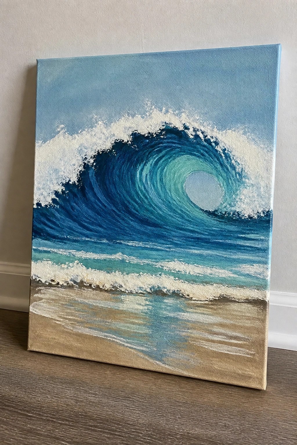 Painting of a large curling blue wave with white foam above sandy beach.