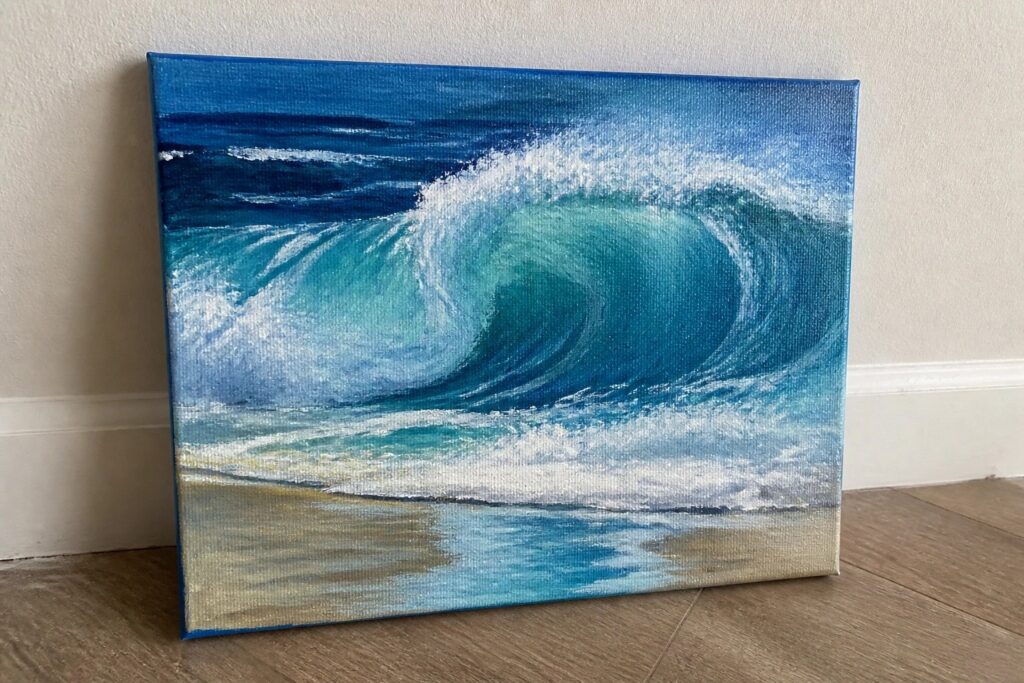 24 Refreshing Ocean Painting Ideas Centered Around Waves, Shorelines, and Sky Painting of a large curling blue wave with white foam above sandy beach.